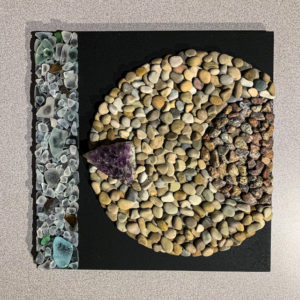 Homage to A Pandemic XXV, rock, sea glass, crystal, and painted wood, 12” X 12.”