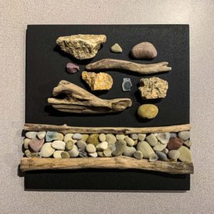 Homage to A Pandemic LV, Driftwood, beach glass and rock on painted wood, 12” X 12”.